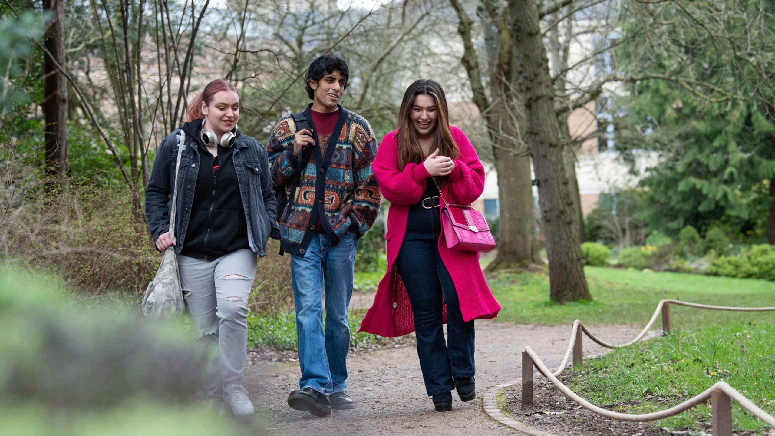 Three Futures Scholars laughing and smiling as they walk through Royal Fort Gardens.