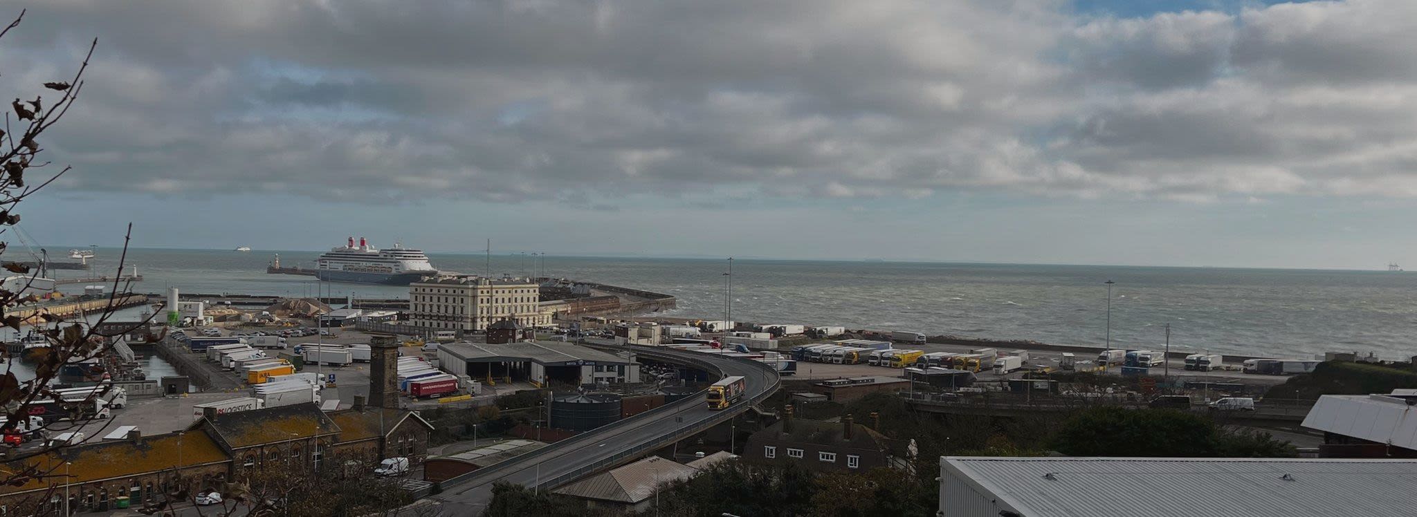 A ferry boat is in the water next to a dock